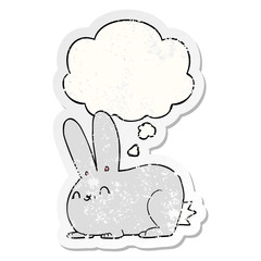 cartoon rabbit and thought bubble as a distressed worn sticker