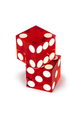 Two red glass luxury dice isolated on white background. One cube lies on the other with a shadow, full clipping. Macro shooting, selective focus.