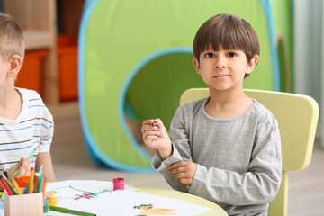 Cute little children drawing in kindergarten