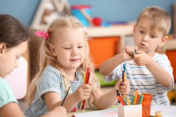 Cute little children drawing in kindergarten
