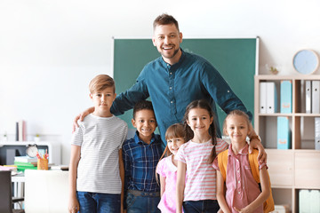 Cute children with teacher in classroom