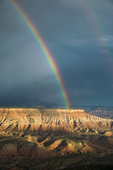 Vibrant rainbow over cliffs near Zion