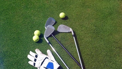 Golfing equipment lying on a golf course.