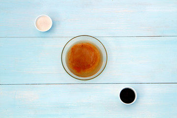 Cooking process Kombucha tea and sugar on a wooden table background.