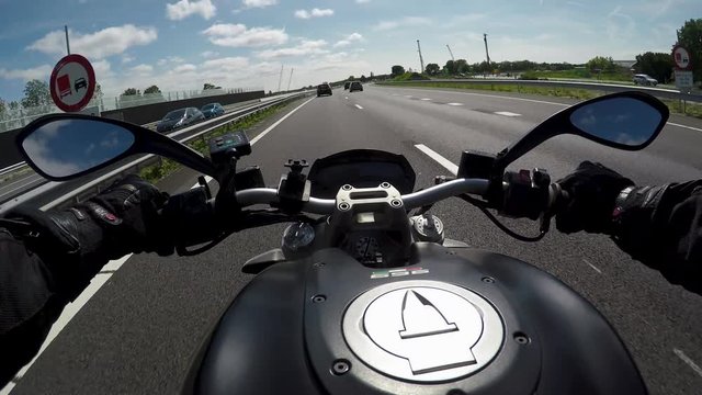 Driving a motorbike on the highway on a sunny day with blue skies
