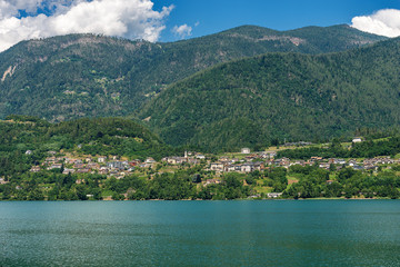 Fototapeta na wymiar Caldonazzo lake (Lago di Caldonazzo) with the Alps and small village of Ischia, Valsugana valley, Trento province, Trentino Alto Adige, Italy, Europe
