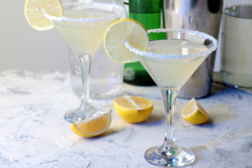 Margarita cocktail, Alcoholic drink, Margarita cocktail with lemon and mint on a bright table. bar. bar supplies and accessories