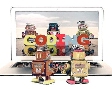 two retro bobots learn about codeing on a laptop computer i