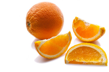 Orange. Ripe juicy orange and slices on a white background. Close-up