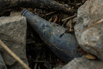 Hazardous waste, glass bottles in rocks, environmental pollution