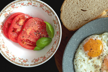 Fried egg and tomatoes with basil.