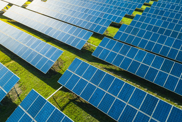 Aerial view of Solar Panels Farm (solar cell) with sunlight. Drone flight over solar panels field,...