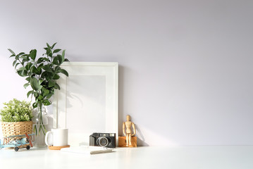 Obraz na płótnie Canvas Mockup workspace desk and copy space books,plant and coffee on white desk.
