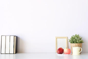 Mockup workspace desk and copy space books,plant and coffee on white desk.