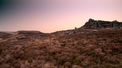 Dramatic moody Winter landscape image of Peak District in England during soft afternoon light