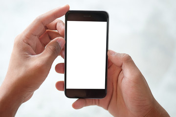 Cropped shot view of man hands holding smart phone with blank copy space screen for your text message or information content, female reading text message on cell telephone during in urban setting. 