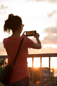 Girl take picture in sunset Hong Kong