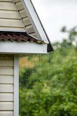 Storm rain drips down from the roof