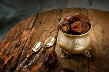 Dried date palm fruits or kurma, ramadan food. Beautiful bowl full of date fruits symbolizing Ramadan. Close -up.
