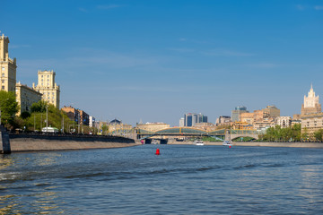 Naklejka premium Moscow, Russia - May 6, 2019: View of the pleasure boat on the Moscow River, Savvinskaya Embankment and the Foreign Ministry building in the spring afternoon