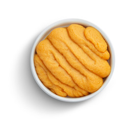 Pumpkin and carrot baby puree in bowl isolated on white background, top view
