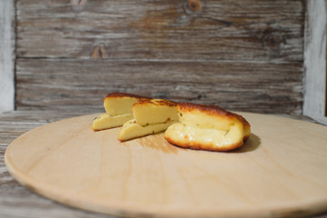 Delicious, fried and healthy Halloumi cheese on a light wooden tray on a beautiful wooden background