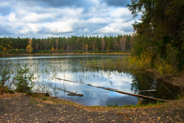 Fototapeta na wymiar Beautiful forest lake old quarry rainy and gloomy autumn day