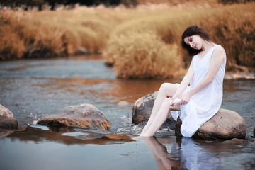 Pregnant woman in nature for a walk in the autumn