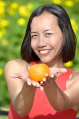 Diverse Female Smiling With An Orange