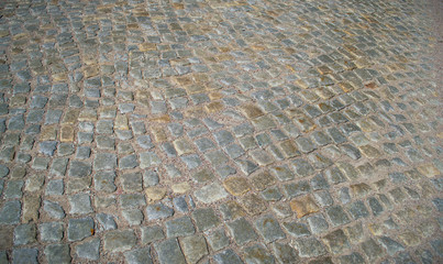 Texture of an old paving stone road from European countryside