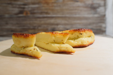 Delicious, fried and healthy Halloumi cheese on a light wooden tray on a beautiful wooden background