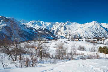 Fototapeta na wymiar Panoramic view across snow covered alpine mountain range