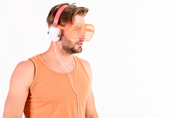 relax playlist. sexy muscular man listen music from playlist. man relax in earphones isolated on...