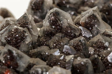 Macro of a stone Ilvaite mineral on a white background