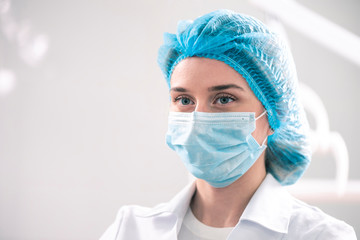 Young caucasian woman in the dentistry with a mask on her face