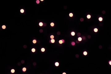 Black festive background with shining hexagonal bokeh lights