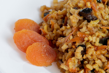 sweet pilaf with dried apricots, carrots, prunes, raisins and turmeric, cooked in olive oil in a slow cooker