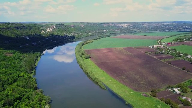 Flight over the river and forest at spring time. Dniester river of Moldova republic.