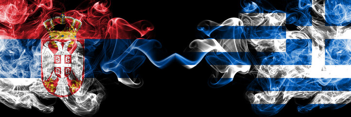 Serbia vs Greece, Greek smoky mystic flags placed side by side. Thick colored silky smokes combination of Serbian and Greece, Greek flag