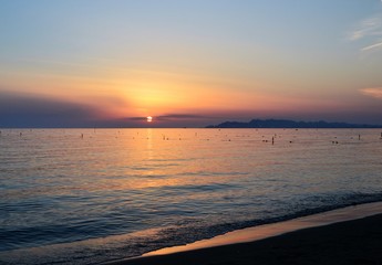 Sunset over Adriatic Sea. View from Golem / Durres, Albania. Beautiful sunset with Durres town silhouette in the distance