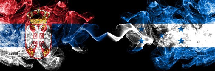 Serbia vs Honduras, Honduran smoky mystic flags placed side by side. Thick colored silky smokes combination of Serbian and Honduras, Honduran flag