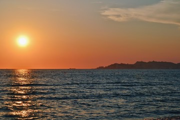 Sunset over Adriatic Sea. View from Golem / Durres, Albania. Beautiful sunset with Durres town silhouette in the distance