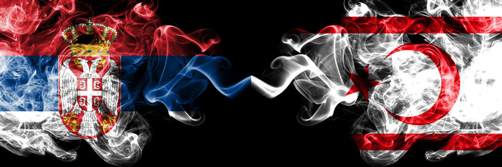 Serbia vs Northern Cyprus smoky mystic flags placed side by side. Thick colored silky smokes combination of Serbian and Northern Cyprus flag