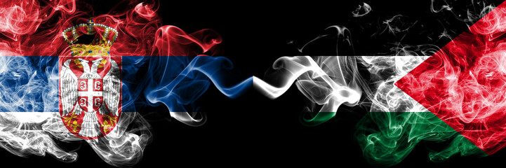 Serbia vs Palestine, Palestinian smoky mystic flags placed side by side. Thick colored silky smokes combination of Serbian and Palestine, Palestinian flag