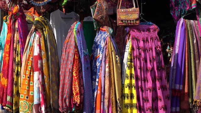 Assortment of colorful clothes for sale in local street market in Udaipur, Rajasthan, India. Close up