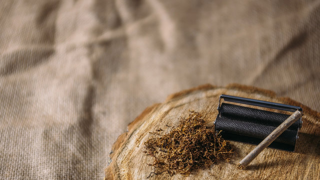 Rolled up cigarret on the wood