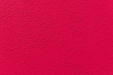 Pink painted cement wall, uneven concrete surface