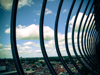 View over historic part of Groningen city under blue sky with clouds with black iron fence