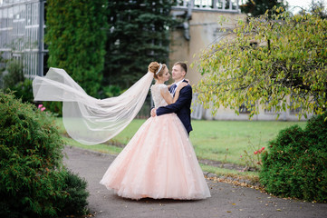 Fototapeta premium the groom whirls with his bride in the park