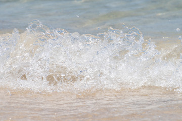 Macro shot of some sea waves hitting the beach